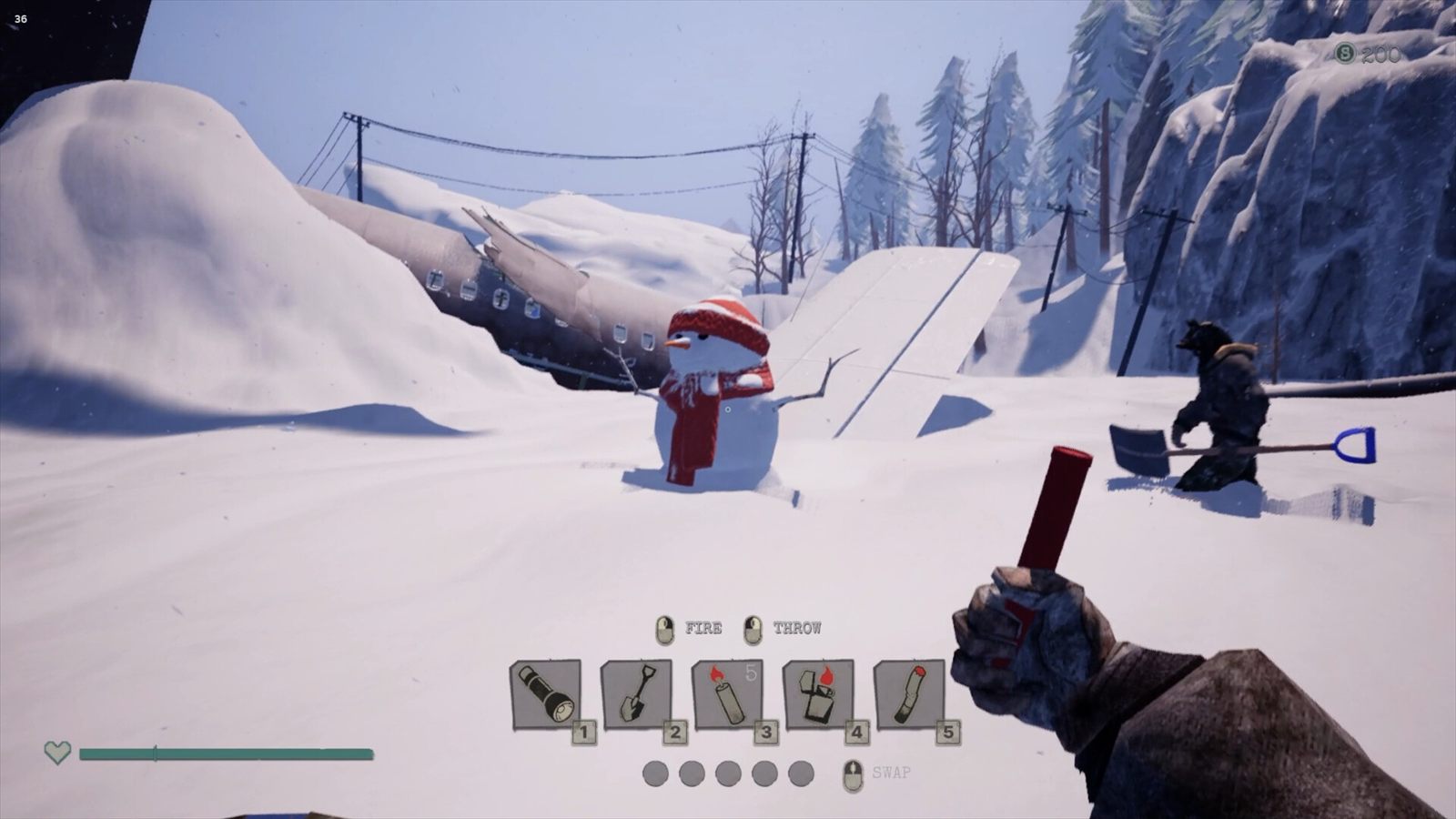 Two players digging beside a snowman at dusk